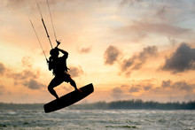A Kite Surfer Rides The Waves