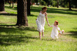 © LIGHTFIELD STUDIOS - mother and daughter walking at park
