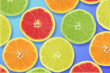 Some citric fruits on a blue background. Fresh seasonal concept 
