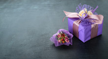 Small Handmade Purple Gift Box Little Bouquet Wrapped In Paper On Dark Background. For The Celebration Of Different Holidays