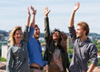 © Roman Babakin - Group of young friends raising their hands up