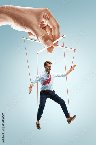 Cuadros en Lienzo Businessman puppet on gray background