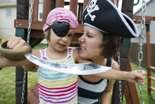 Mother And Daughter In Pirates Costumes Playing At Playground