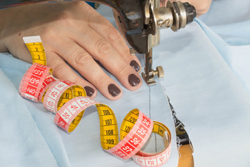 Wall Mural - processes of sewing on the sewing machine sew women's hands sewing machine