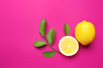 Sticker - Delicious fresh lemons with green leaves on color background