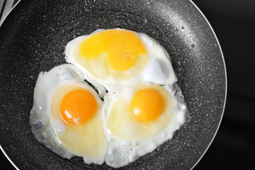 Wall Mural - Frying pan with delicious eggs, closeup