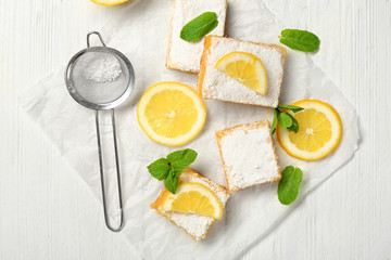 Wall Mural - Delicious lemon pie bars and sieve with powdered sugar on wooden table