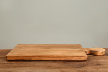 Canvas Print - Wooden board on table against grey background