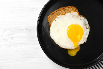 Wall Mural - Delicious over easy egg with bread on kitchen table