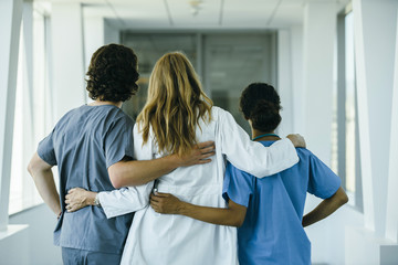 Wall Mural - Doctor and nurses hugging