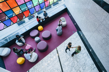 Wall Mural - Overhead view of people meeting and working in lobby of office
