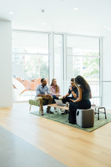 Wall Mural - Diverse group of coworkers meeting in modern office space