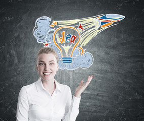 Wall Mural - Blonde woman pointing at a startup idea sketch