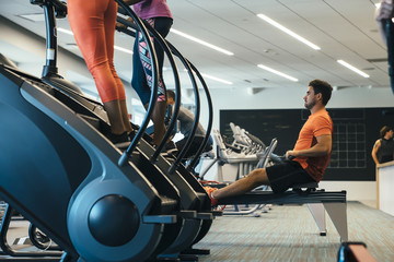 Group of men and women working out at a gym 