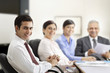 © IndiaPix - Happy business people smiling in meeting room