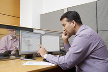 Business Executive Looking At A Graph On A Computer Monitor