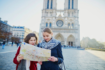 Wall Mural - Two young girls taking selfie near Notre-Dame in Paris