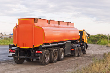 Lorry with orange tanker on parked on the roadside