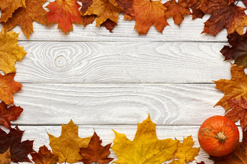 Sticker - Autumn leaves and pumpkin over old wooden background