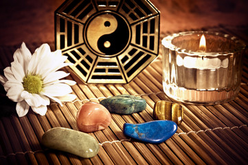 Wall Mural - ying yang, i-ching with healing stones, candle and a daisy flower like a concept of chinese oriental