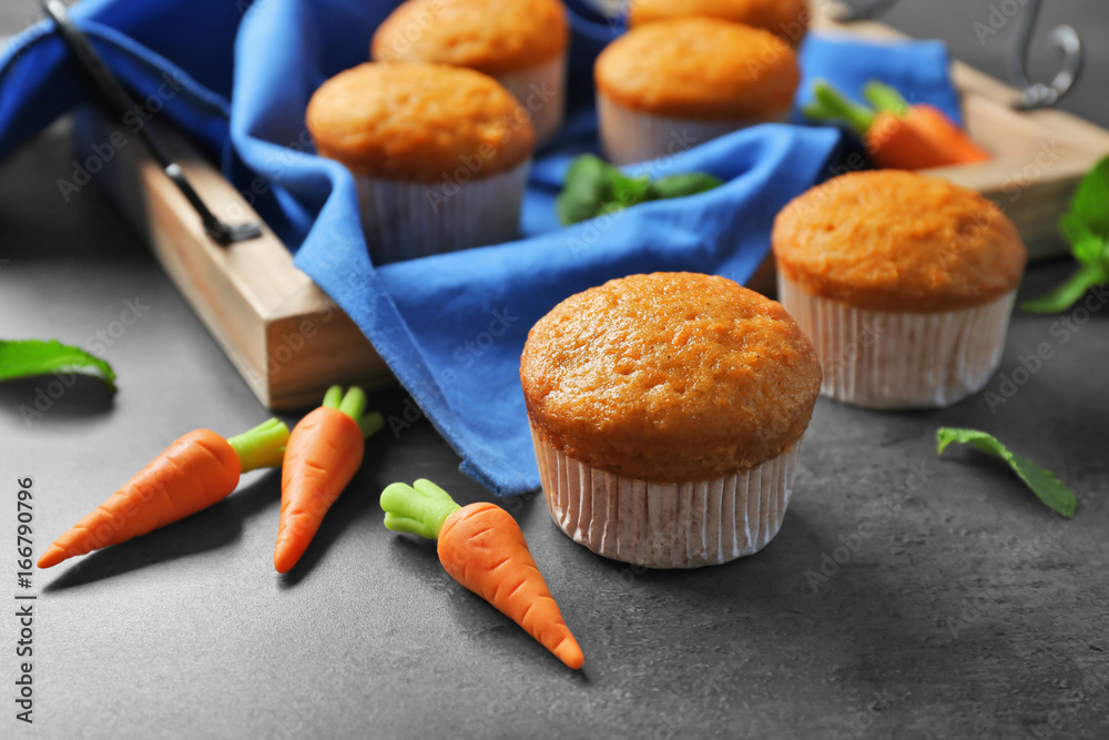 Composition with delicious carrot muffins on grunge table