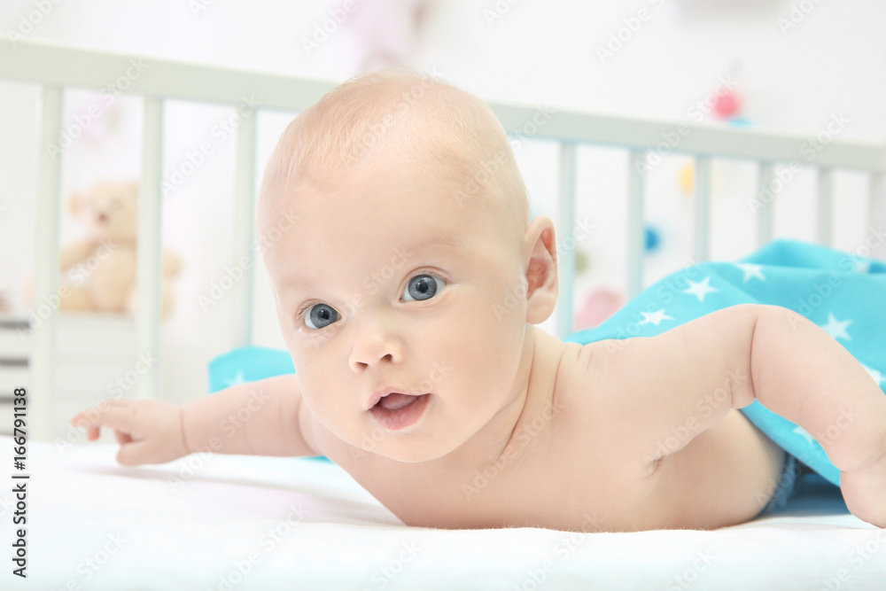 Emotional baby lying in cradle. Insomnia and sleep disorders concept