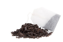 A Bag Of Black Tea And Tea Leaves On A White Background