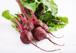 Young beetroot with a tops on a white background.