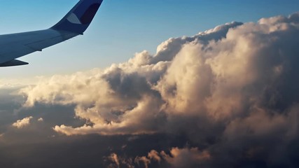 Wall Mural - flying over the evening clouds with the late sun. flight through moving cloudscape with beautiful su