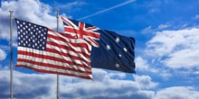 Australia And America Waving Flags On Blue Sky. 3d Illustration