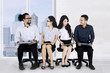 © Creativa Images - Employees chat while waiting for interview
