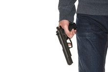 Armed Person Holding Handgun Wearing Dark Blue Jeans And Hoodie Isolated On White Background, Copy Space, Close-up On Gun