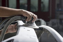 Auto Body Repair Series: Closeup Of Mechanic Sanding Car Bumper