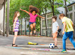 © Sergey Novikov - Group of kids play hopscotch on the school