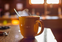 Soft Focus Steaming Cup Of Coffee In Early Morning - Earth Tone Palette