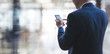 © bunditinay - Businessman using smart phone on interior space with futuristic technology connection shape over the network connection background