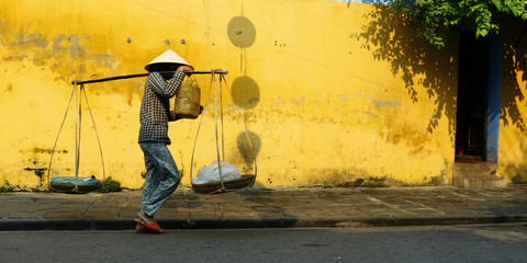 street seller in the street of hoi an