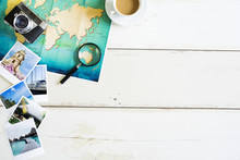 Traveller Desk With Folded Paper Map Of World And Photos