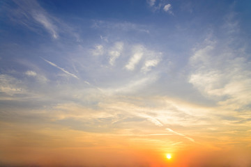 Wall Mural - sunset / sun rise sky with rays of yellow and red light shining clouds and sky background and textur