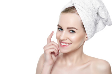 Wall Mural - beautiful young blond woman applying face cream under her eyes. facial treatment. cosmetology, beaut