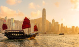Fototapeta  - Chinese wooden red sails ship in Hong Kong Victoria harbor at sunset time