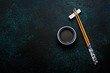 © Tatyana Sidyukova - Japanese sushi chopsticks and soy sauce bowl on blue dark stone background