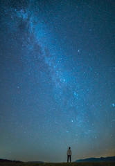 The man stand on the background of the stars in the sky. night time