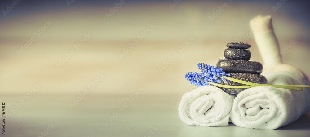 Spa or wellness setting with massage equipment and flowers, front view, banner - obrazy, fototapety, plakaty 