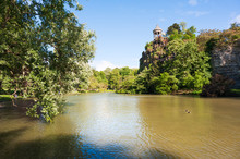 Parc Des Buttes Chaumont Lake On A Sunny Day, France