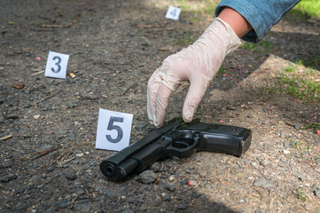 Investigator collects evidence - crime scene investigation