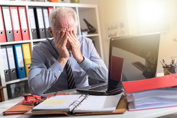 Tired businessman with headache, light effect