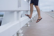 © SIMPILI - Suicide jumper on the bridge with river below.