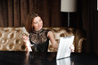 © nagaets - Woman in a restaurant relaxing with glass of champagne and tablet pc