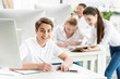© LIGHTFIELD STUDIOS - portrait of smiling student looking at camera while sitting at table during lesson in classroom